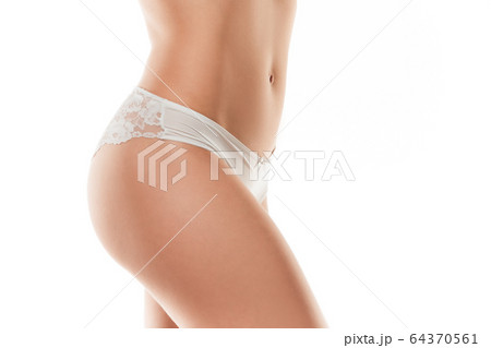 Beautiful female belly and legs isolated on white background. Beauty, cosmetics, spa, depilation, treatment and fitness concept, sensual posing 64370561