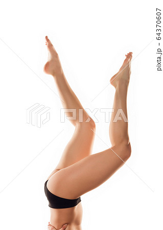 Beautiful female legs isolated on white background. Beauty, cosmetics, spa, depilation, treatment and fitness concept, sensual posing 64370607