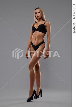 Woman in lingerie isolated on grey. Woman in lingerie isolated on grey. 64371691
