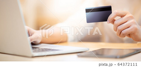 Male customer hand using credit card for online 64372111