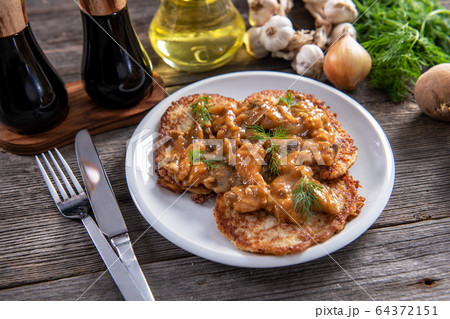 Tasty homemade potato pancakes with meat and 64372151