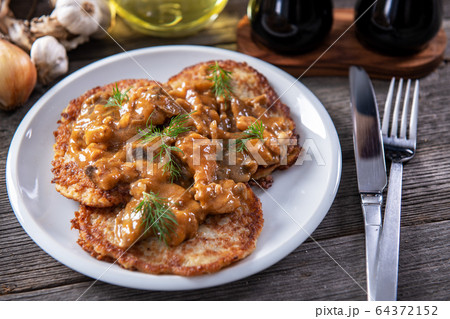 Tasty homemade potato pancakes with meat and 64372152