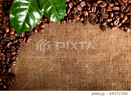 Coffee background with roasted beans and leaves Coffee background with roasted beans and leaves 64372300