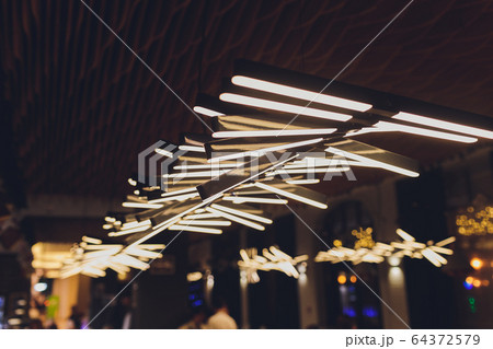 Luxury interiors of Chandelier Light pattern background at modern building. Luxury interiors of Chandelier Light pattern background at modern building. 64372579