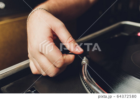 Close up acoustic vinyl player with dj hand. Close up acoustic vinyl player with dj hand. 64372580