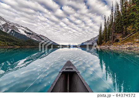 Canoeing on Maligne lake with altocumulus clouds Canoeing on Maligne lake with altocumulus clouds 64374572