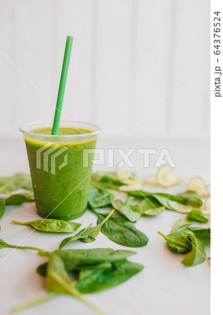 Row of healthy fresh fruit and vegetable smoothies with assorted ingredients 64376524