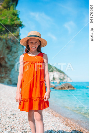 Cute little girl at beach during summer vacation Cute little girl at beach during summer vacation 64376634