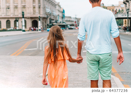 Tourist family in popular area in Havana, Cuba. 64377236