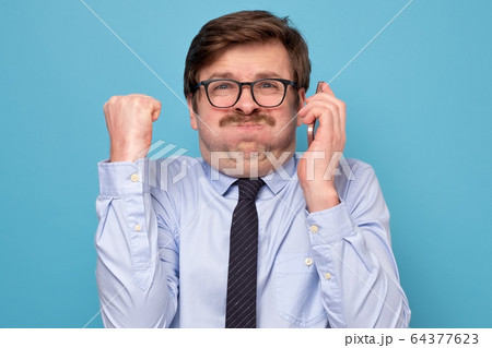 Pissed off angry mature guy with mustache in black 64377623