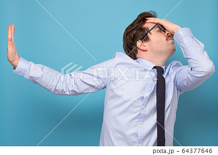 Caucasian tired man in tie and blue shirt refusing 64377646