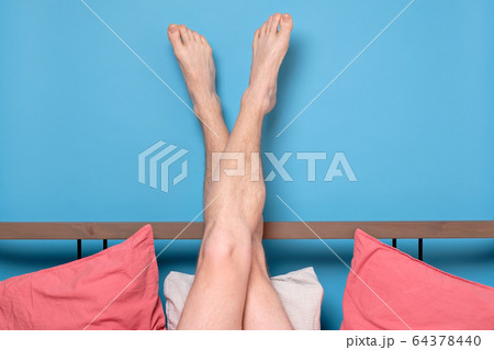 man legs resting in quarantine at bed at home. man legs resting in quarantine at bed at home. 64378440