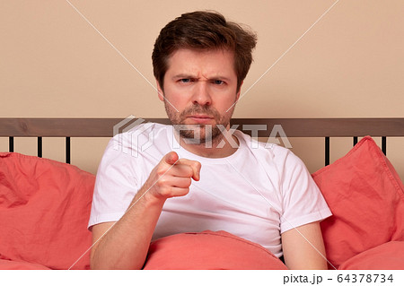 Angry man pointing his finger at you sitting in Angry man pointing his finger at you sitting in 64378734