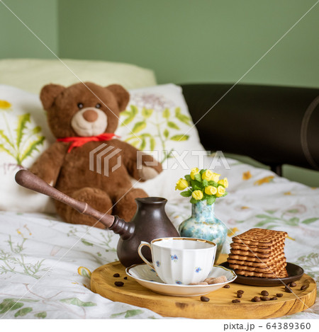 Breakfast in bed with a cezve, a cup, a vase of Breakfast in bed with a cezve, a cup, a vase of 64389360