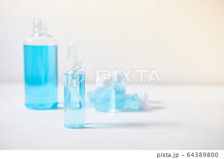Closeup bottle of blue alcohol hand spray. 64389800