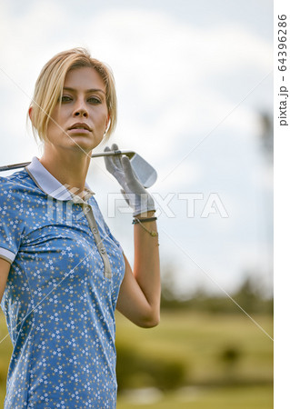 Portrait of a beautiful woman playing golf on a green field outdoors background. The concept of golf, the pursuit of excellence, personal excellence, royal sport. Portrait of a beautiful woman playing golf on a green field outdoors background. The concept of golf, the pursuit of excellence, personal excellence, royal sport. 64396286