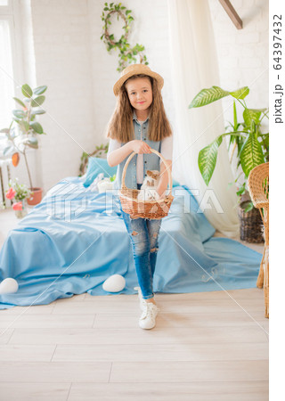 Cute girl with easter bunnies in the room decorative for the holiday. Easter mood 64397432