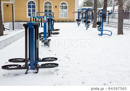 An outdoor gym equipment covered with snow An outdoor gym equipment covered with snow 64397565
