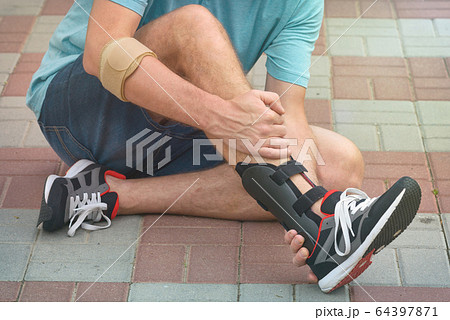 Man wearing ankle brace Man wearing ankle brace 64397871