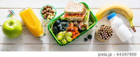 Back to school concept - lunch box with juice, apple and banana Back to school concept - lunch box with juice, apple and banana 64397900