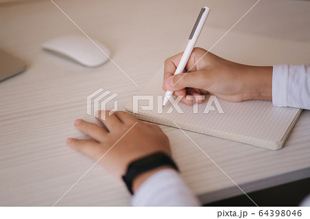 Schoolboy study at desk in his room. Boy use laptop and writing in notebook. Books and tablet on the table. Study home during qurantine Schoolboy study at desk in his room. Boy use laptop and writing in notebook. Books and tablet on the table. Study home during qurantine 64398046