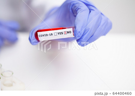 Doctor holds test tube with covid-19 test. 64400460