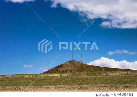 Telecommunications Tower against blue sky on mountains in Himalaya, Tibet. 64400461