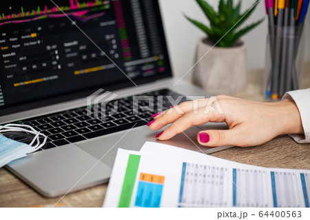 Sad woman is looking at falling stock charts during an epidemic covid-19. Sad woman is looking at falling stock charts during an epidemic covid-19. 64400563