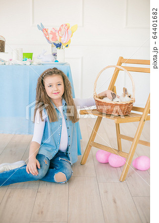 Cute girl with easter bunnies in the room decorative for the holiday. Easter mood 64401682