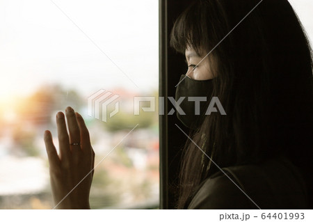Asian woman staying home for self-quarantine and social distancing in coronavirus outbreak situation 64401993