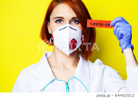 Woman in protective gloves holding inscription covid-19. Woman in protective gloves holding inscription covid-19. 64402012