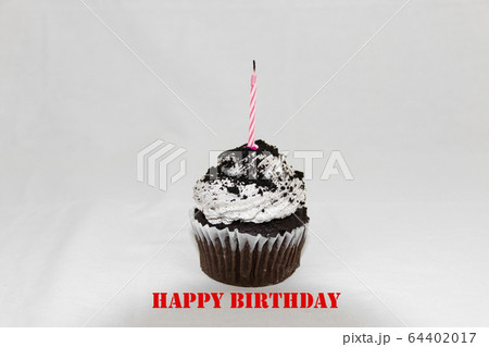 Cookies and cream cupcake with pink candle Cookies and cream cupcake with pink candle 64402017