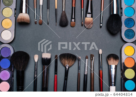 set of brushes and pallets with colored eye shadows set of brushes and pallets with colored eye shadows 64404814