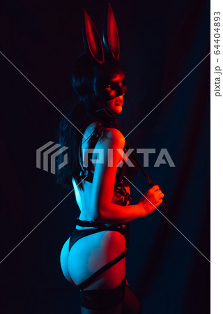 naked girl mistress dominant masked Bunny with leather whip for BDSM sex 64404893
