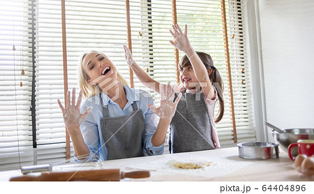 Young Mother and little daughter laughing and Young Mother and little daughter laughing and 64404896