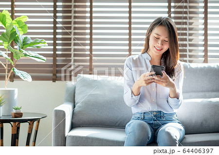 Beautiful woman using mobile phone and internet technology to use online chat with her friends 64406397