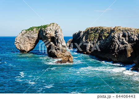 Scenic view of sea against blue sky in rocky coast 64406443
