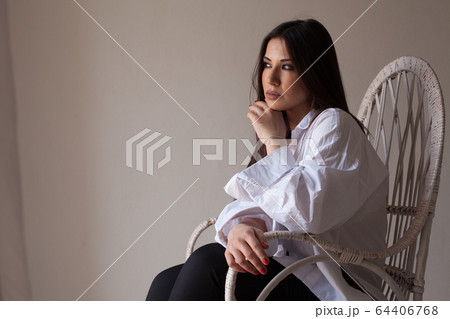 portrait of a beautiful oriental fashionable woman in a white shirt portrait of a beautiful oriental fashionable woman in a white shirt 64406768