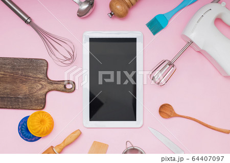 Tools for baking and cooking tablet with blank screen and place for text or image on pink background 64407097