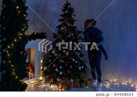 Mom and son Christmas tree Christmas tree gifts lights garlands 64408023