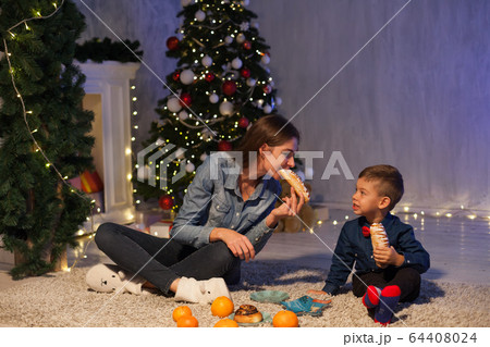 Mom and son Christmas tree Christmas tree gifts lights garlands Mom and son Christmas tree Christmas tree gifts lights garlands 64408024