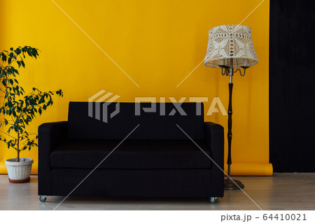 black office sofa in the interior of the room with a yellow background 64410021