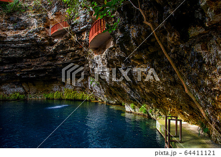 Cenote Ecoturistico X-cajum with blue clear water. 64411121