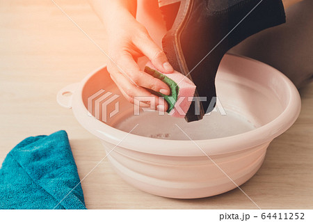 Cleaning and washing dirty shoes concept. Person's Cleaning and washing dirty shoes concept. Person's 64411252