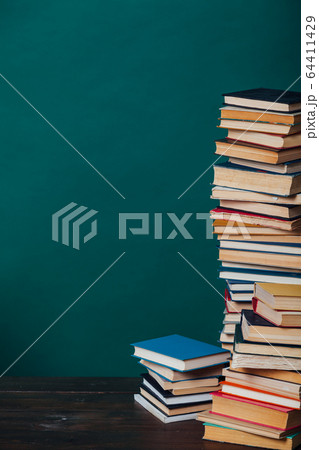 school a lot of different educational books on a green background 64411429