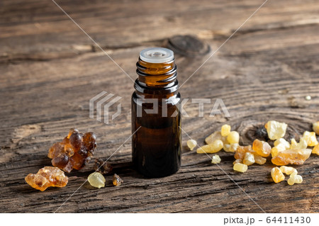 A bottle of frankincense essential oil with frankincense resin 64411430