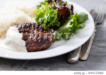 grilled meat with sauce, boiled rice and fresh 64412080