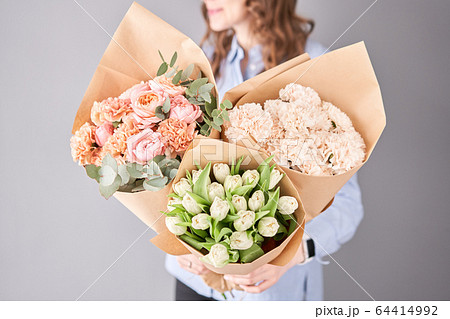 Flowers set in womans hands. Fresh cut flowers for decoration home. European floral shop. Beautiful bouquet of mixed flowers . Delivery fresh cut flower. 64414992