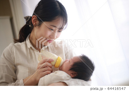 赤ちゃんにミルクを与える母親 64416547