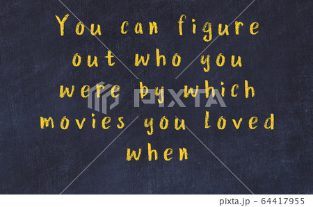 Chalk inscription of smart quote on black desk 64417955